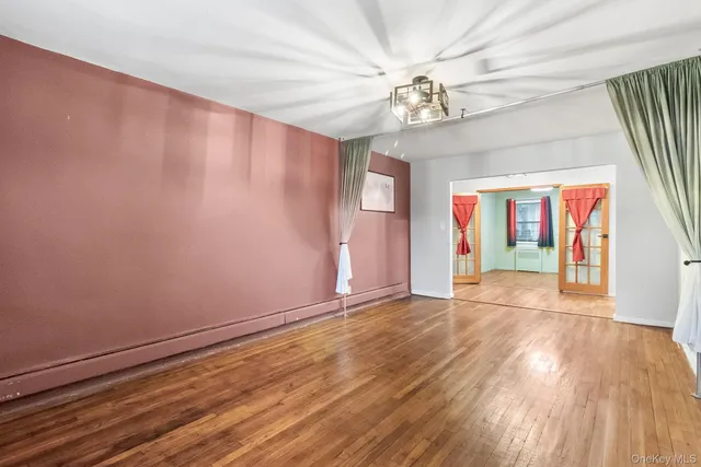 wooden floor in an empty room with a window