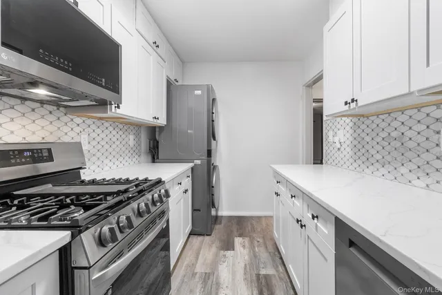 a kitchen with a stove and a white cabinet