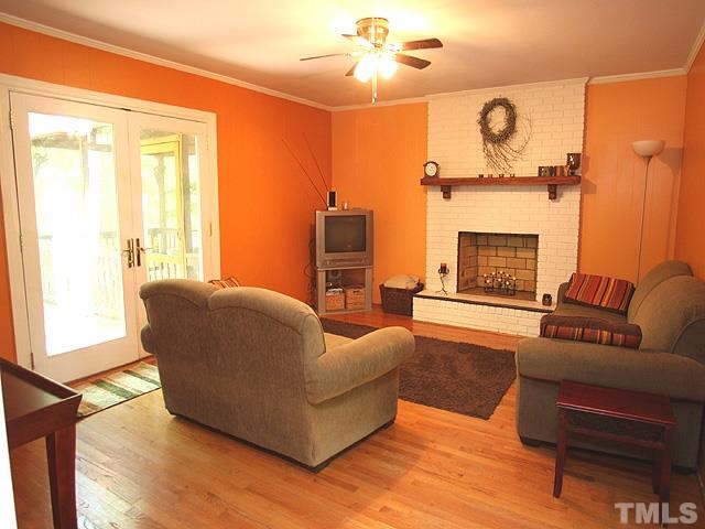 5020 Biscayne Road Durham, NC 27707 - Photo 6 of 13 with fireplace, door leading to screened porch/deck