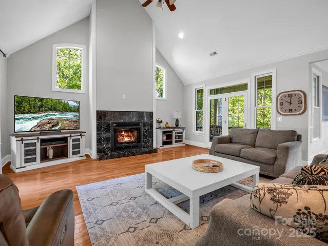 a living room with furniture fireplace and window