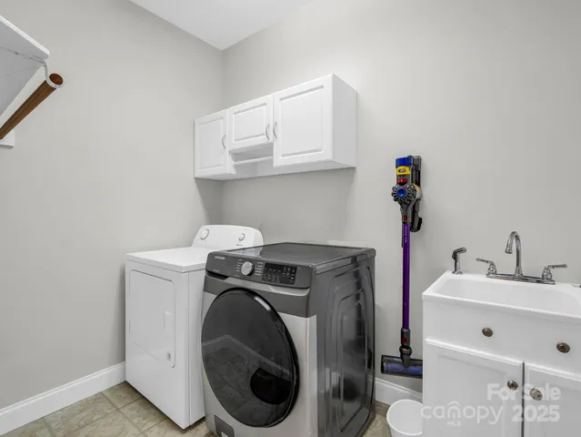 a utility room with sink dryer and washer