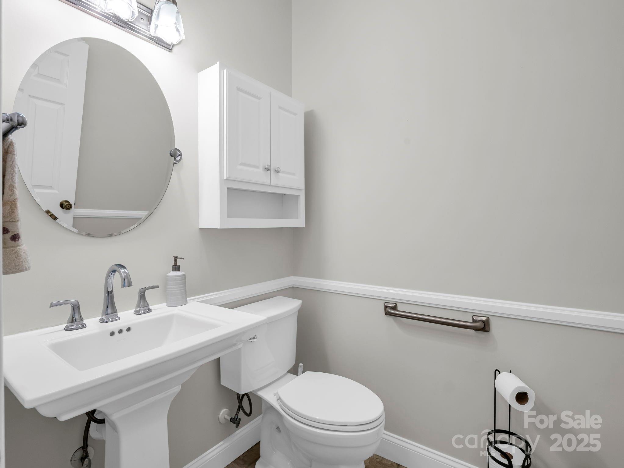 34 West Rambling Creek Tryon, NC 28782 - Photo 22 of 48 a bathroom with a toilet sink and mirror