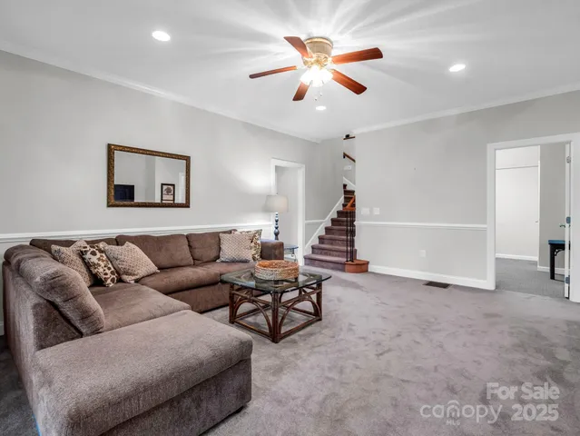 a living room with furniture and a chandelier