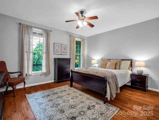 a spacious bedroom with a bed and a dresser