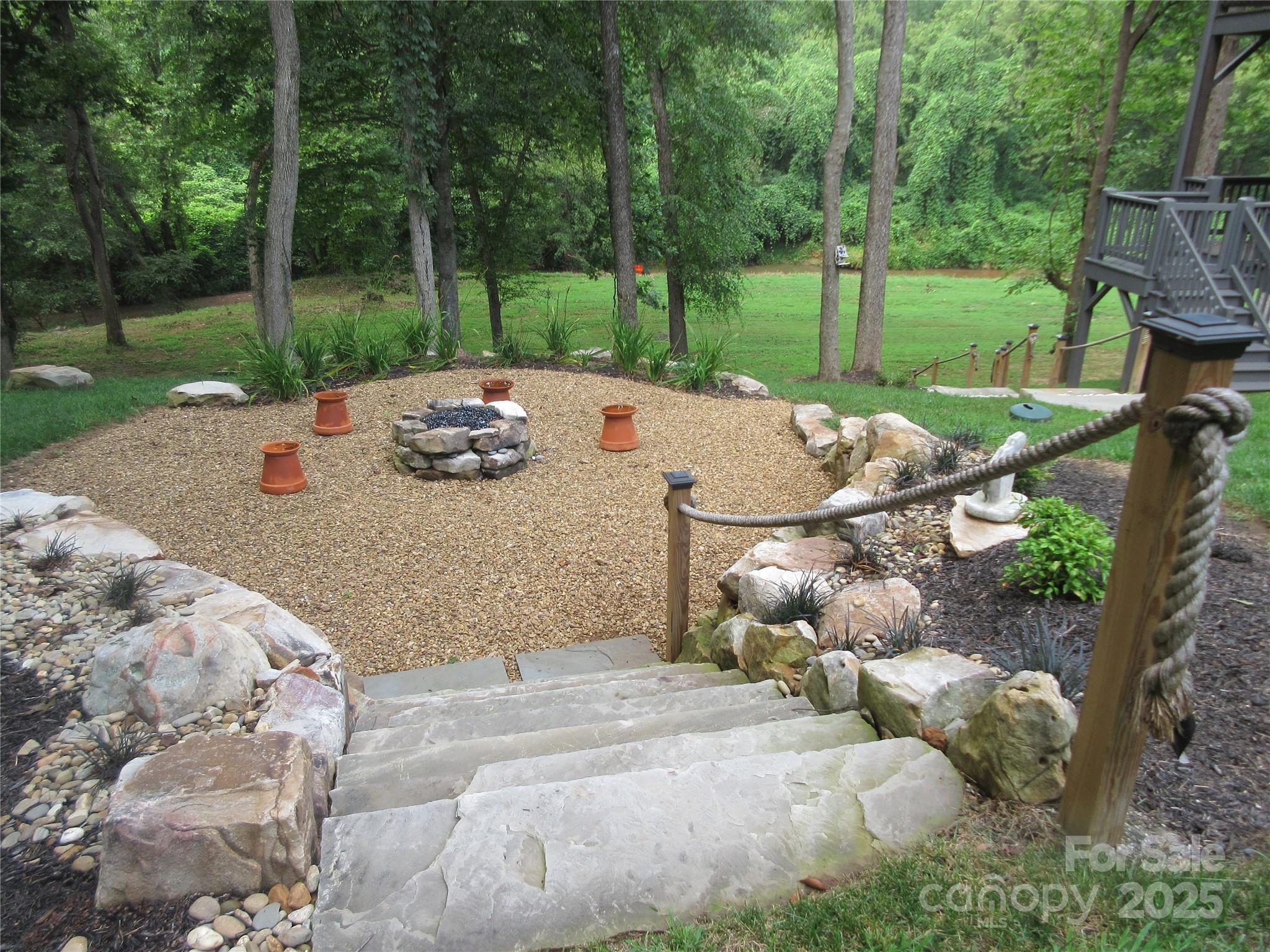 34 West Rambling Creek Tryon, NC 28782 - Photo 3 of 48 a view of a backyard with sitting area and tree