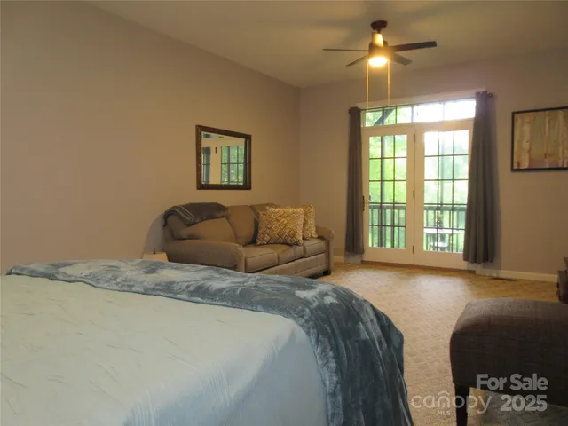 a spacious bedroom with a bed and a chandelier