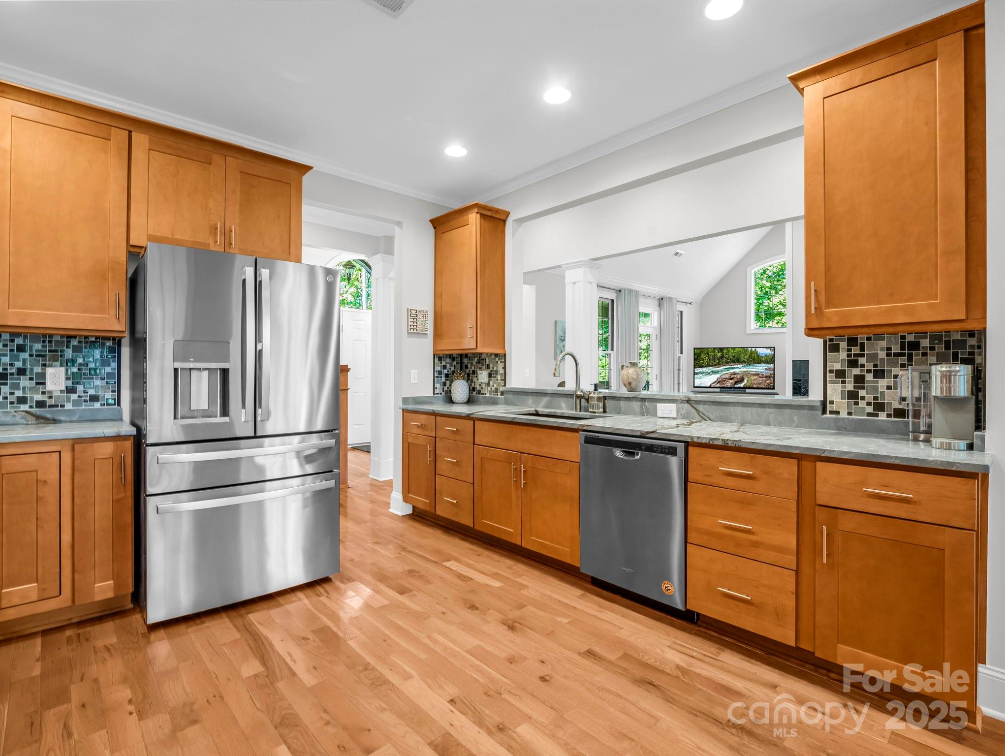 34 West Rambling Creek Tryon, NC 28782 - Photo 8 of 48 a kitchen with stainless steel appliances granite countertop a refrigerator a sink dishwasher a stove with wooden cabinets and wooden floor