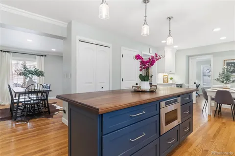 a bathroom with a granite countertop toilet sink and mirror
