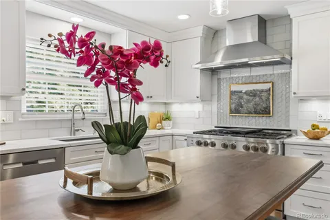 a view of a livingroom with wooden floor and a potted plant