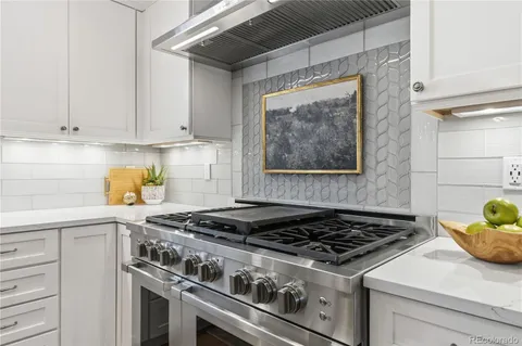 a bathroom with a granite countertop sink mirror vanity and toilet