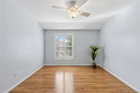 a view of a house with big yard and a large tree