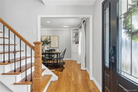 a living room with furniture a fireplace and a potted plant