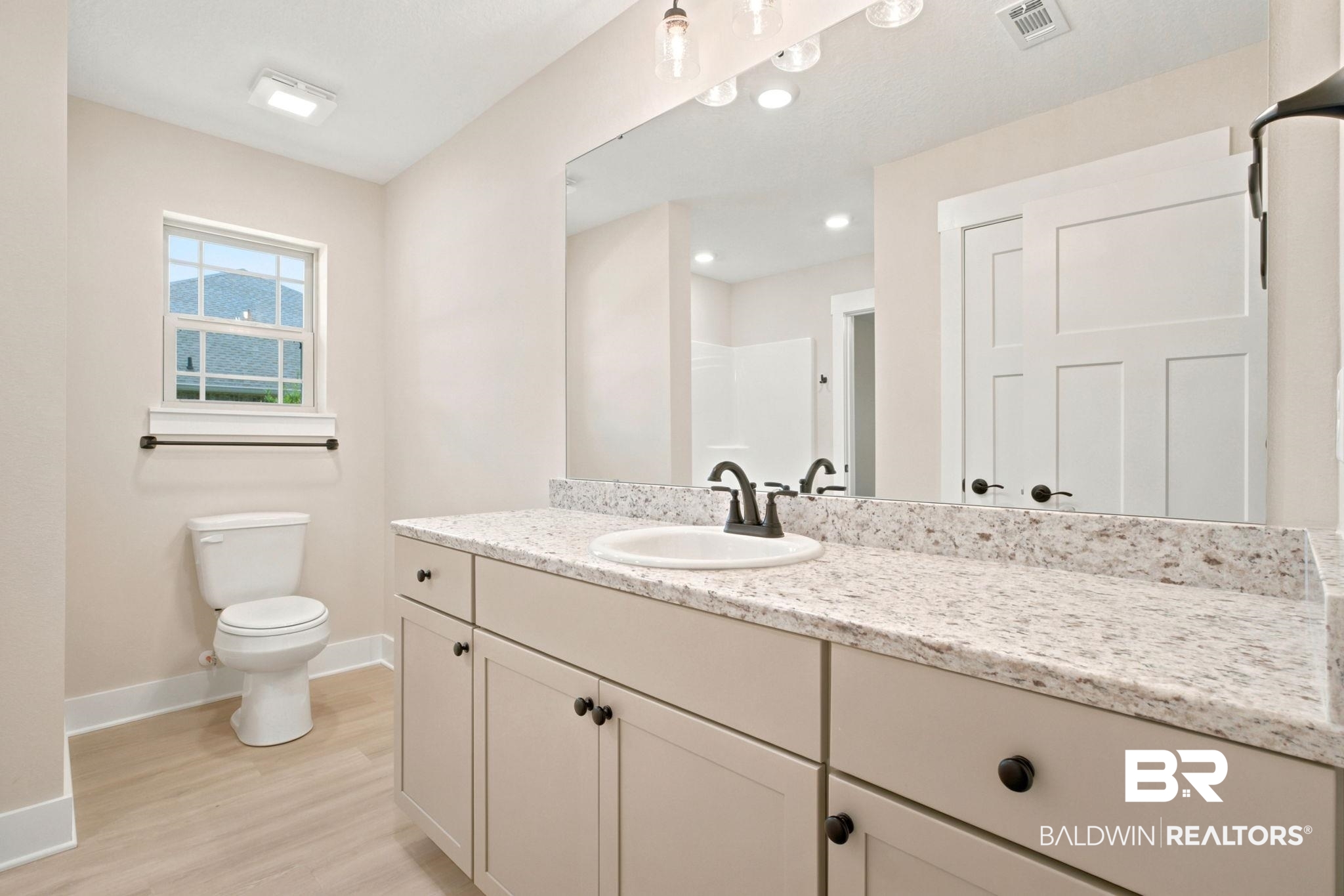 32656 Arbor Ridge Circle Lillian, AL 36549 - Photo 23 of 56 Bathroom featuring a light-toned vanity with a solid surface countertop, an undermount sink, and black hardware