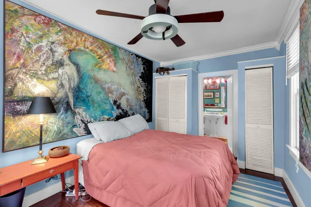 a bedroom with a bed and a chandelier