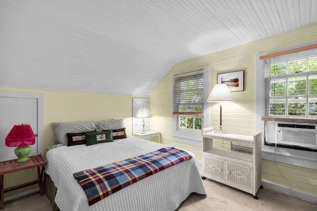 a bedroom with a bed and wall painting