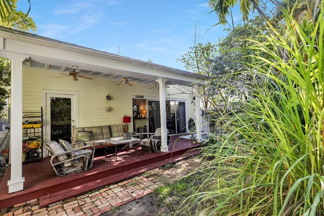 a backyard of a house with table and chairs