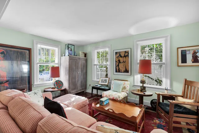 a living room with furniture fireplace and a large window
