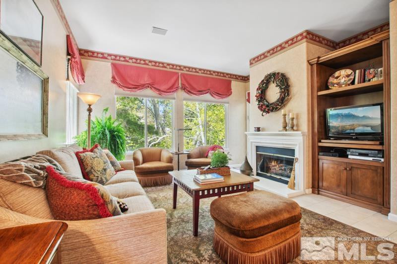 1825 Caughlin Creek Road Reno, NV 89519 - Photo 15 of 40 a living room with furniture a flat screen tv and a fireplace