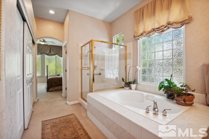 1825 Caughlin Creek Road Reno, NV 89519 - Photo 22 of 40 a spacious bathroom with a tub and shower
