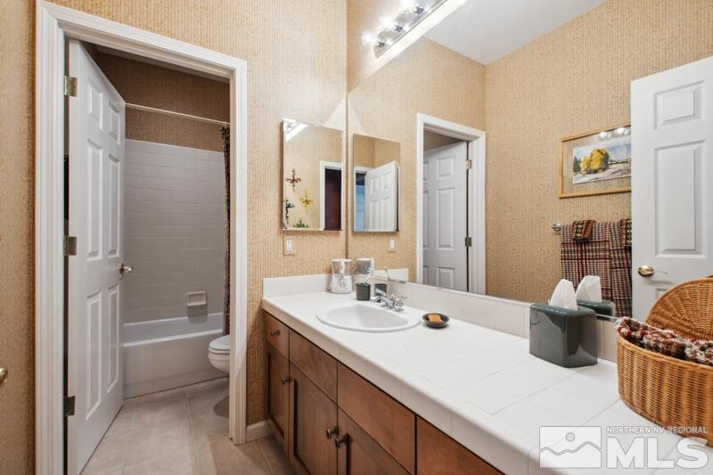 1825 Caughlin Creek Road Reno, NV 89519 - Photo 34 of 40 a bathroom with a sink a toilet and shower