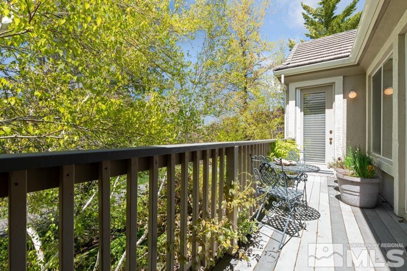 1825 Caughlin Creek Road Reno, NV 89519 - Photo 35 of 40 a balcony with wooden floor and outdoor seating