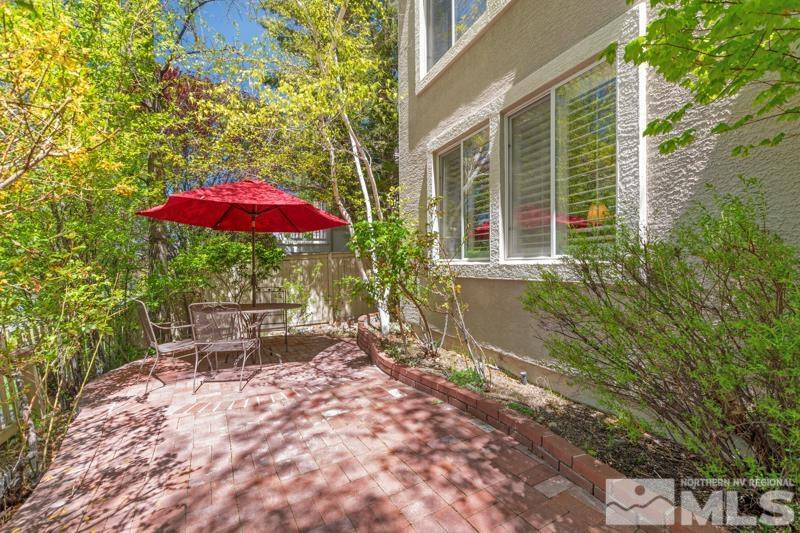 1825 Caughlin Creek Road Reno, NV 89519 - Photo 36 of 40 a view of a patio with chairs and table under an umbrella