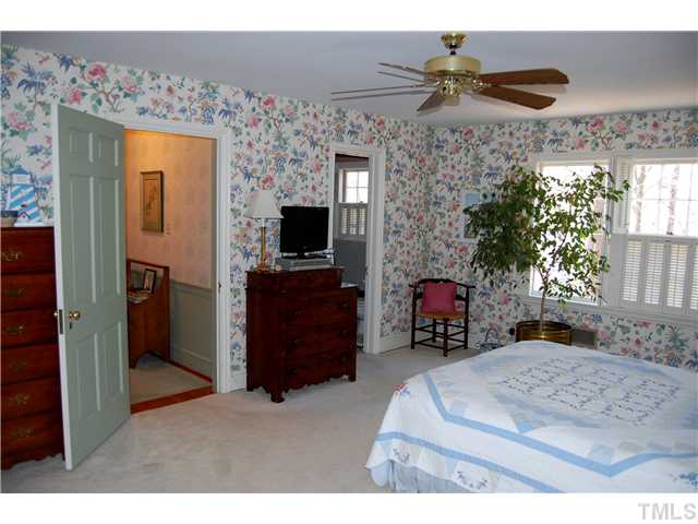 601 Marlowe Road Raleigh, NC 27609 - Photo 14 of 20 a bedroom with a bed and a ceiling fan