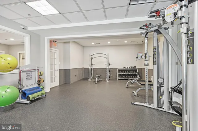 a room with gym equipment and a mirror