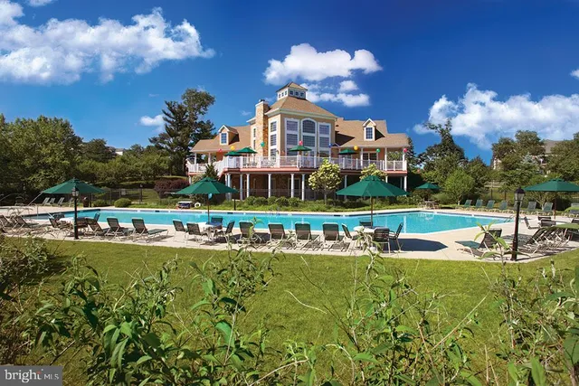 a front view of a house with swimming pool outdoor seating and barbeque oven