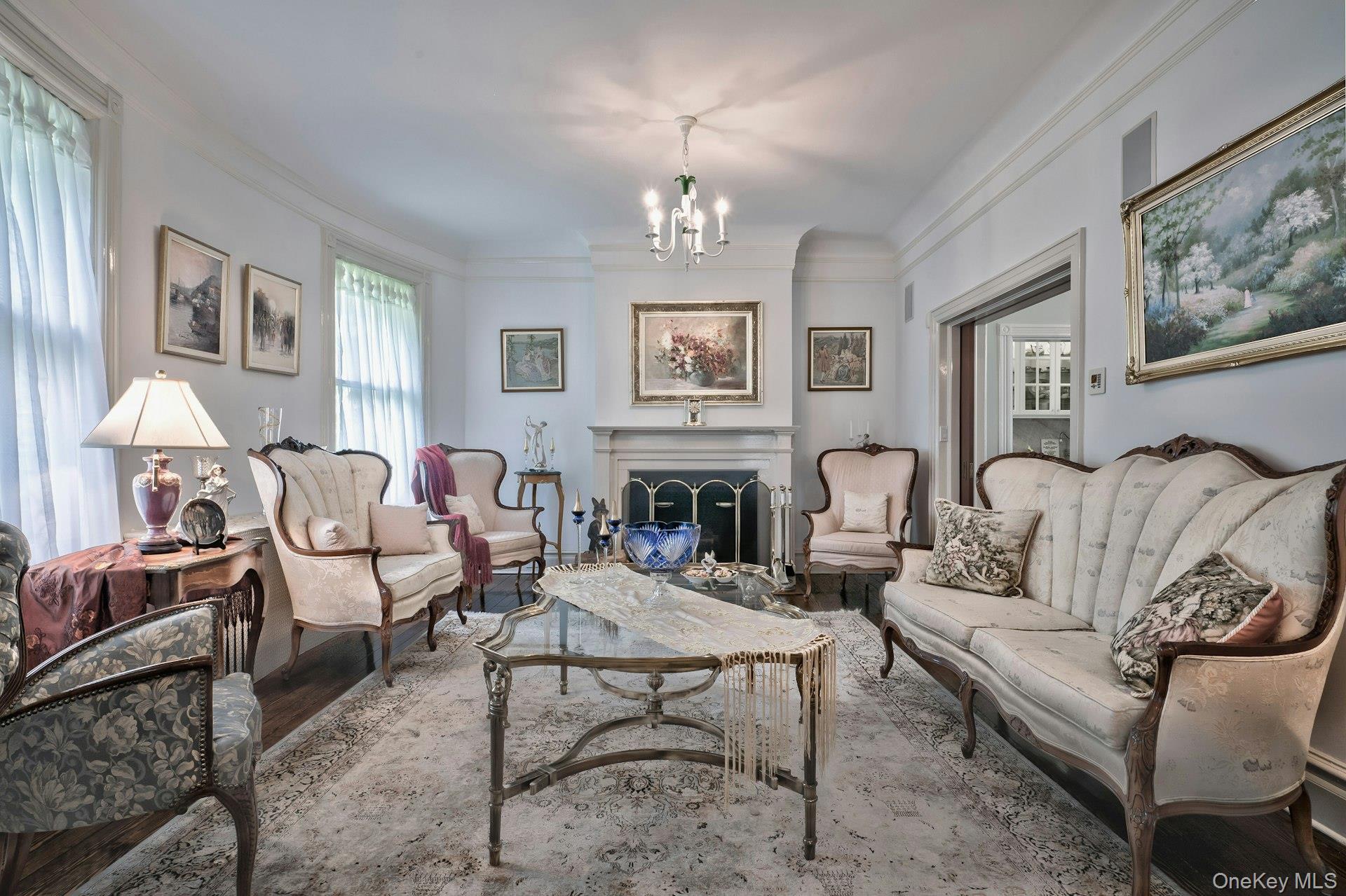 89 Duck Pond Road Glen Cove, NY 11542 - Photo 16 of 48 a living room with furniture chandelier and fireplace