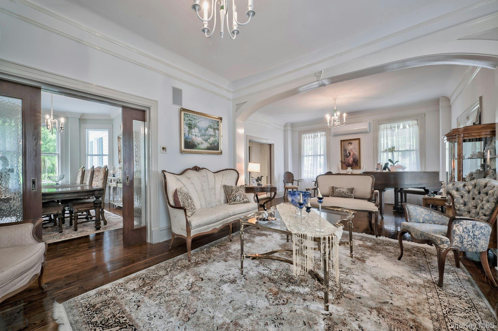 89 Duck Pond Road Glen Cove, NY 11542 - Photo 19 of 48 a living room with furniture wooden floor and a chandelier