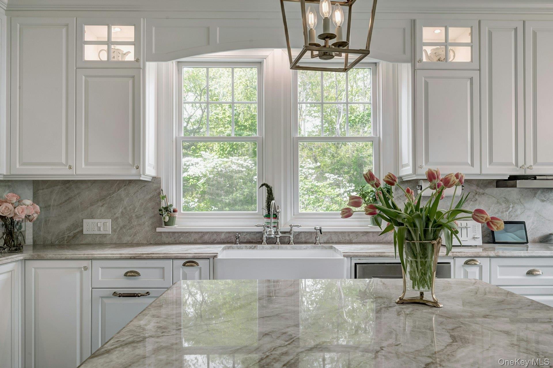 89 Duck Pond Road Glen Cove, NY 11542 - Photo 26 of 48 a view of a kitchen with granite countertop a window a sink and white cabinets