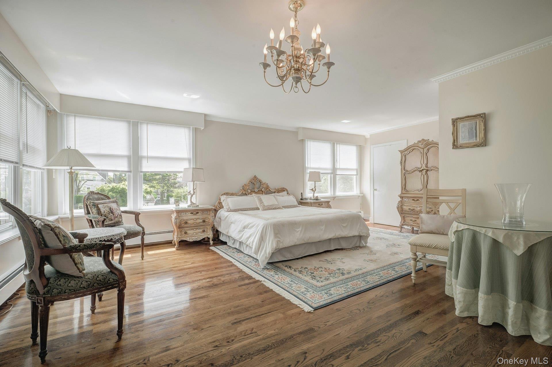 89 Duck Pond Road Glen Cove, NY 11542 - Photo 34 of 48 a bedroom with a bed wooden floor and windows