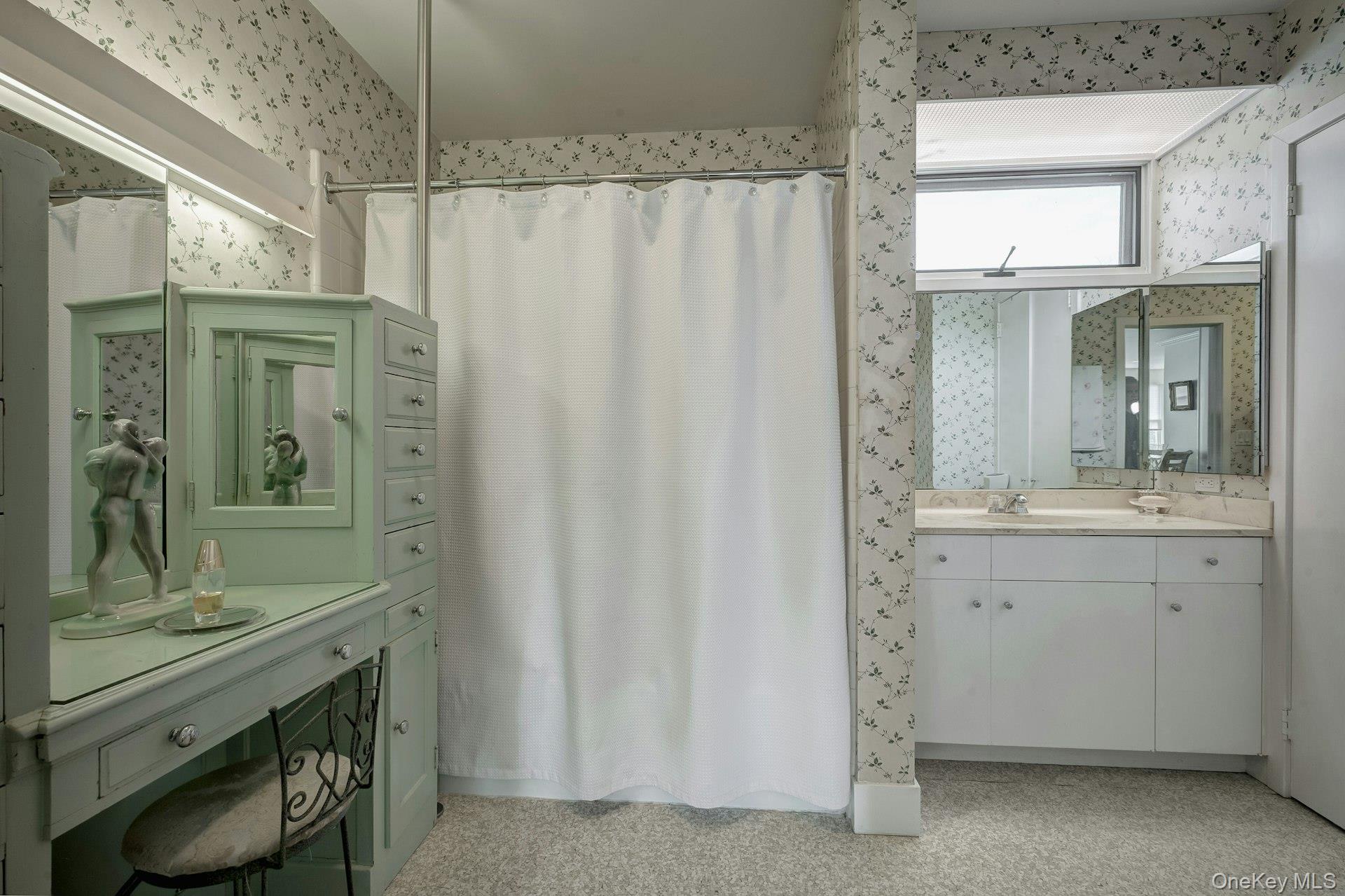 89 Duck Pond Road Glen Cove, NY 11542 - Photo 35 of 48 a bathroom with a sink a mirror and a shower
