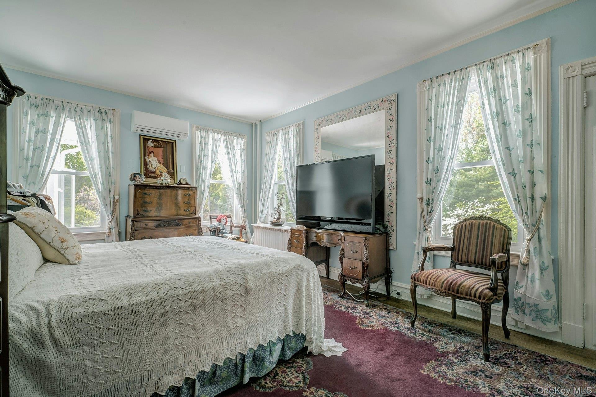 89 Duck Pond Road Glen Cove, NY 11542 - Photo 36 of 48 a bedroom with a bed and a flat screen tv