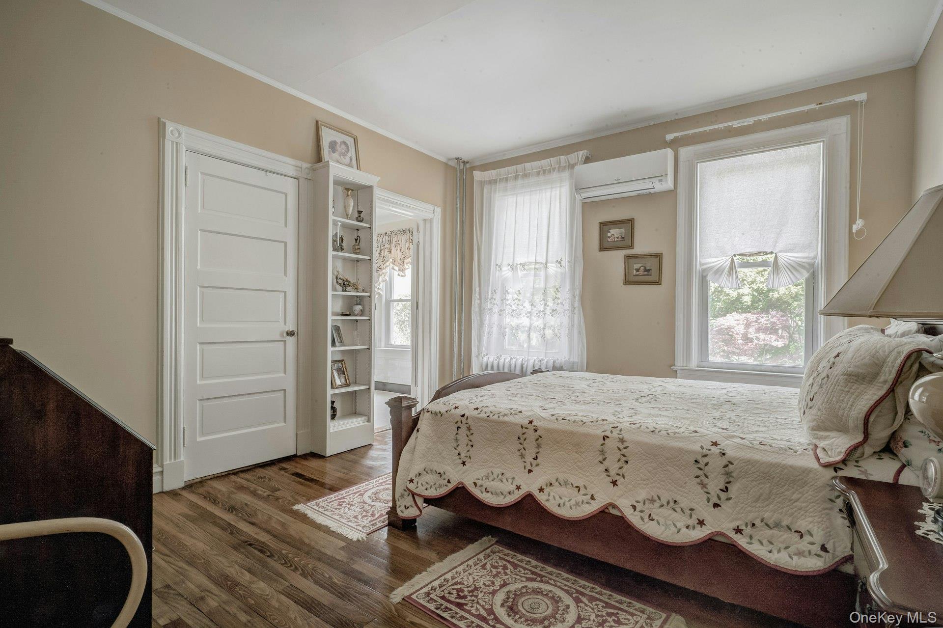 89 Duck Pond Road Glen Cove, NY 11542 - Photo 38 of 48 a bedroom with a bed and wooden floor