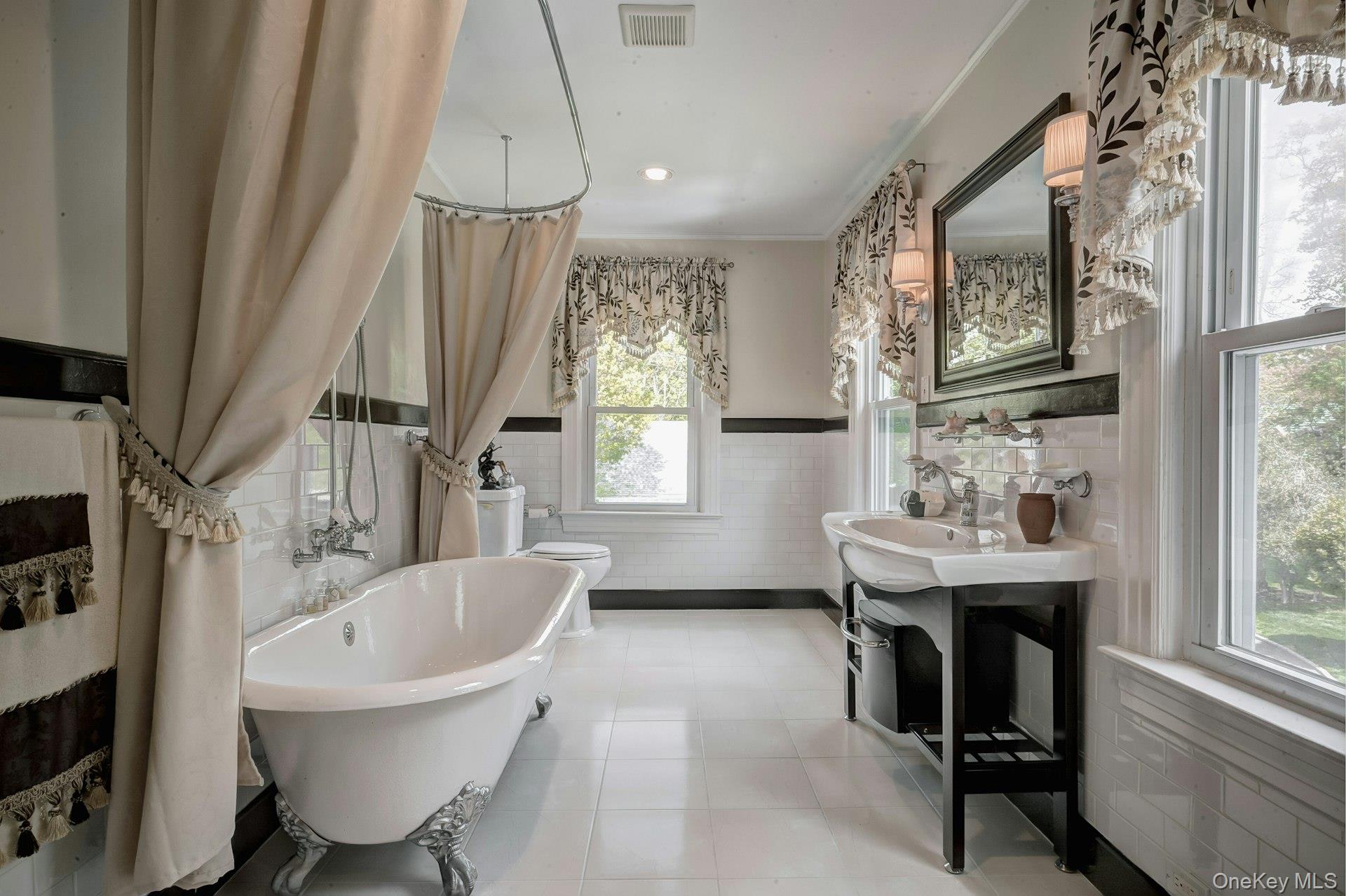 89 Duck Pond Road Glen Cove, NY 11542 - Photo 39 of 48 a bathroom with a bathtub sink and window