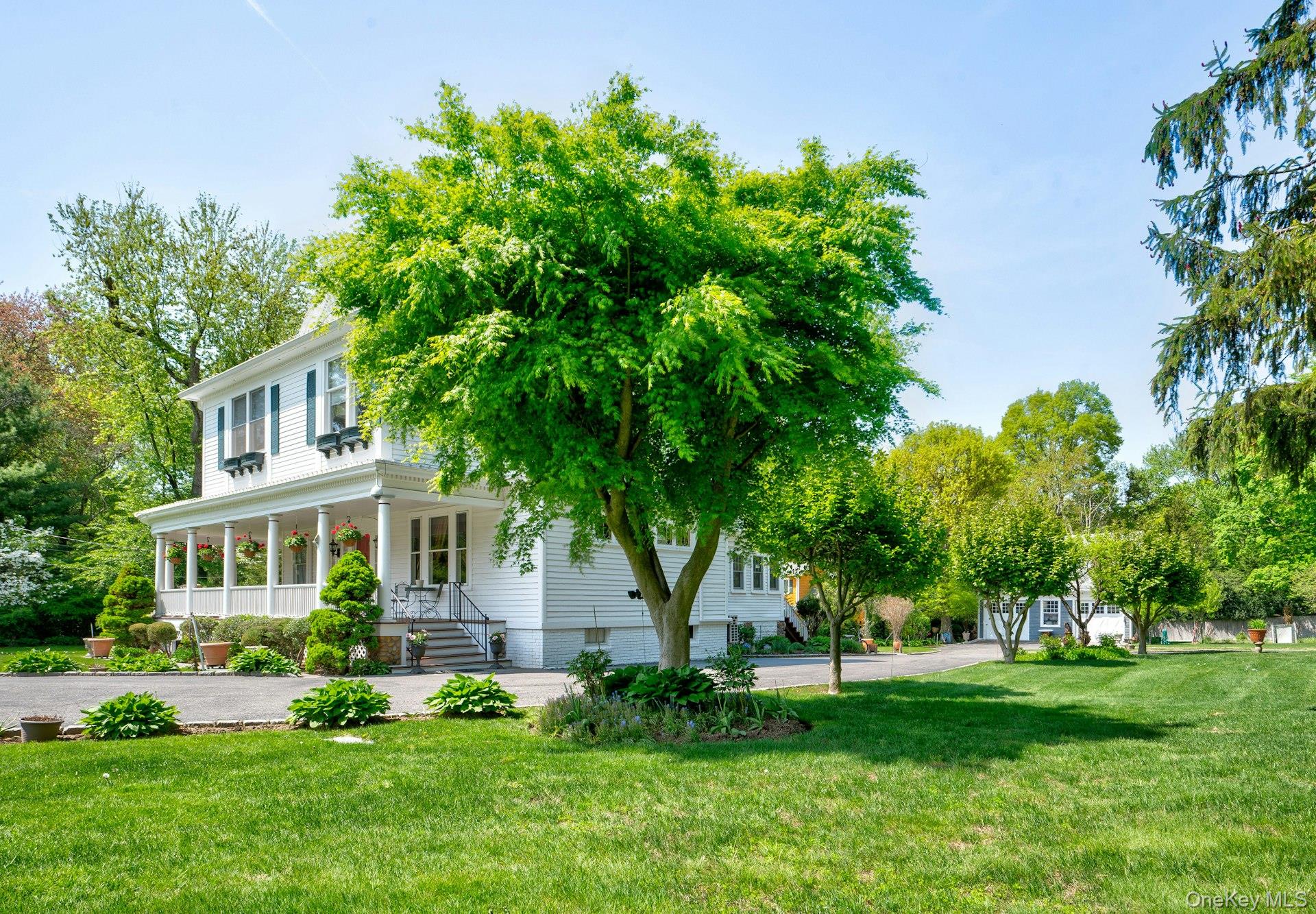 89 Duck Pond Road Glen Cove, NY 11542 - Photo 4 of 48 a front view of a house with a yard and trees