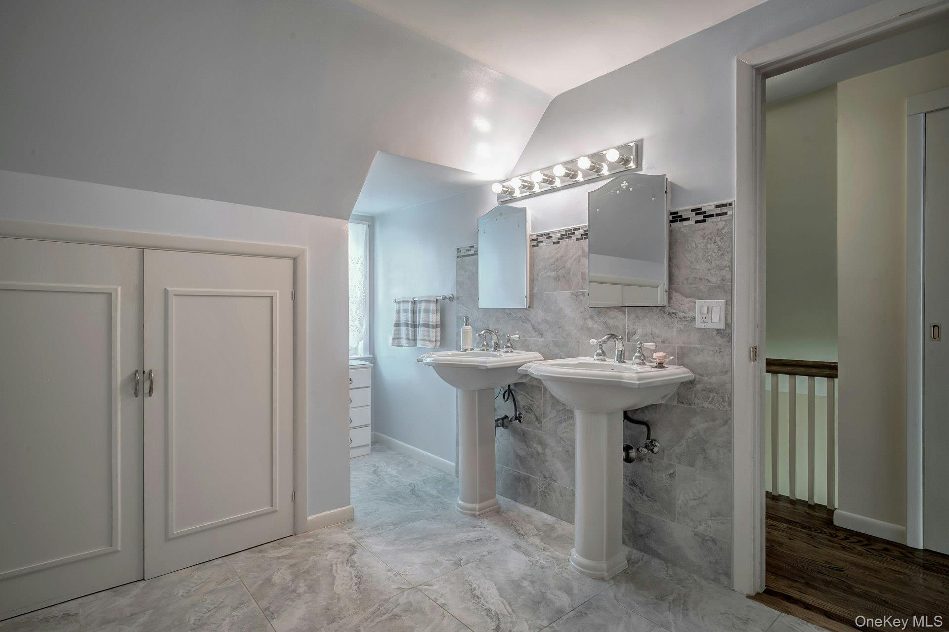 89 Duck Pond Road Glen Cove, NY 11542 - Photo 42 of 48 a bathroom with a sink and mirror