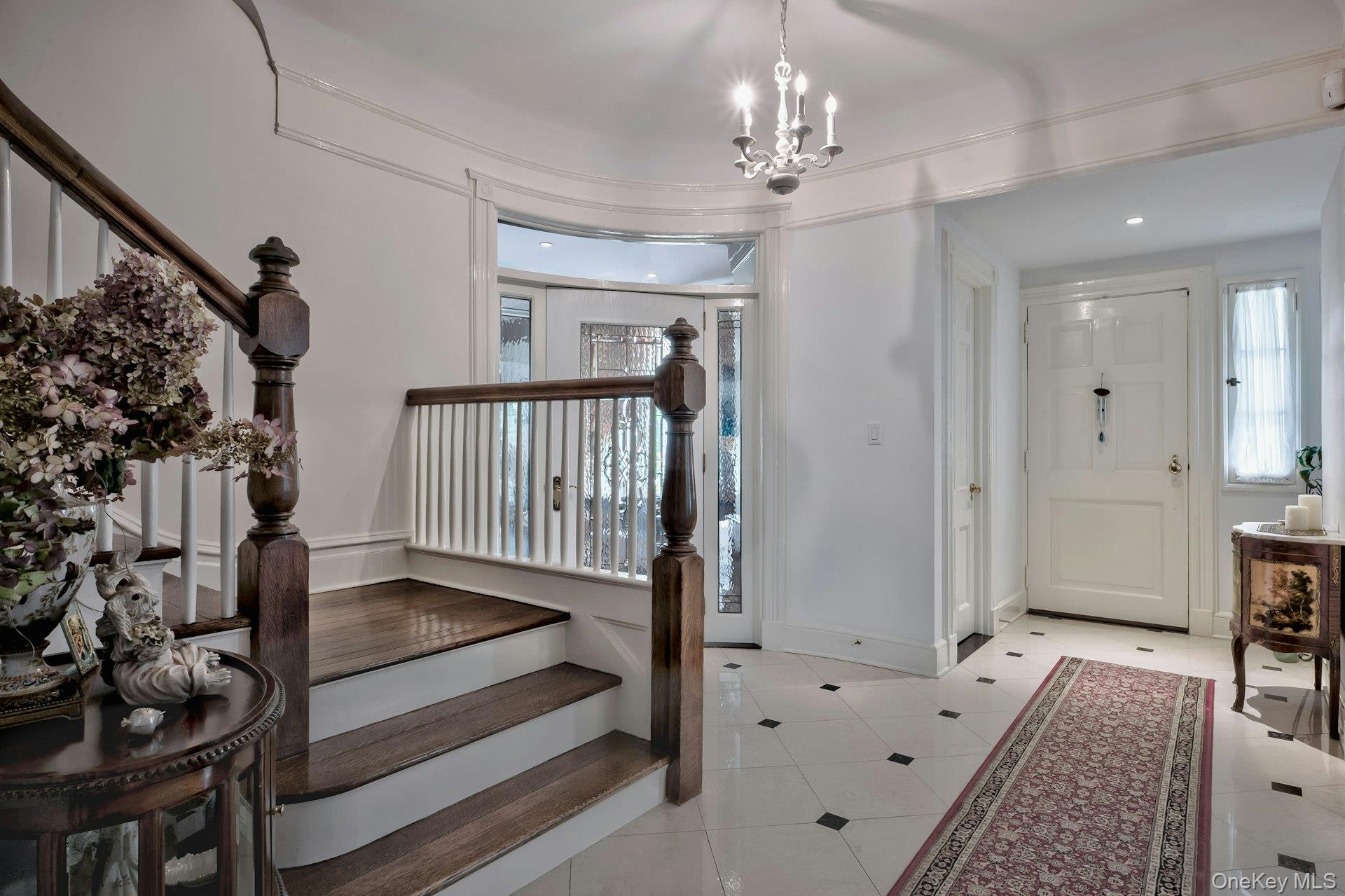89 Duck Pond Road Glen Cove, NY 11542 - Photo 9 of 48 a view of a hallway with wooden floor and staircase
