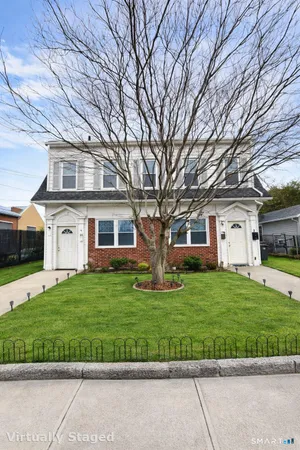 a front view of a house with a garden