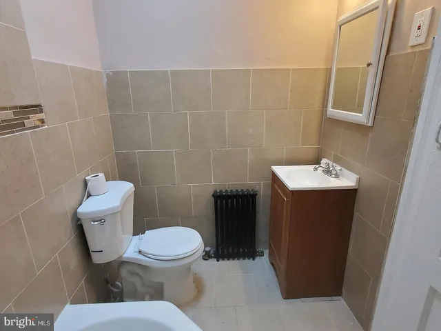 a white toilet sitting next to a bathroom sink