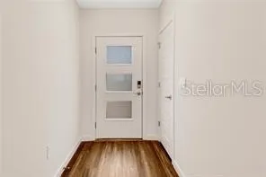 a view of front door with wooden floor