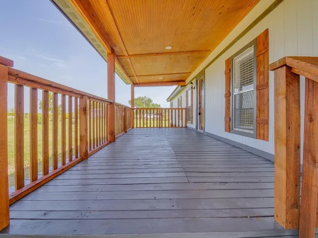 a view of balcony with wooden floor