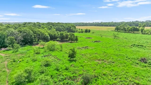 a view of a lake and green valley