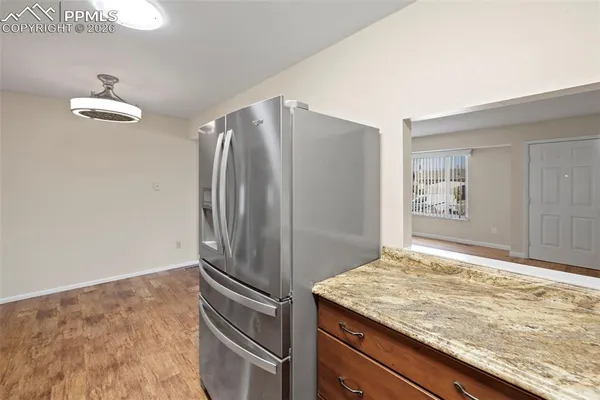a kitchen with kitchen island a refrigerator and stove