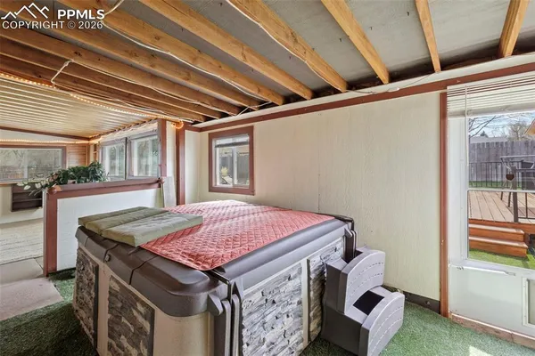 a bed sitting in a bedroom next to a window