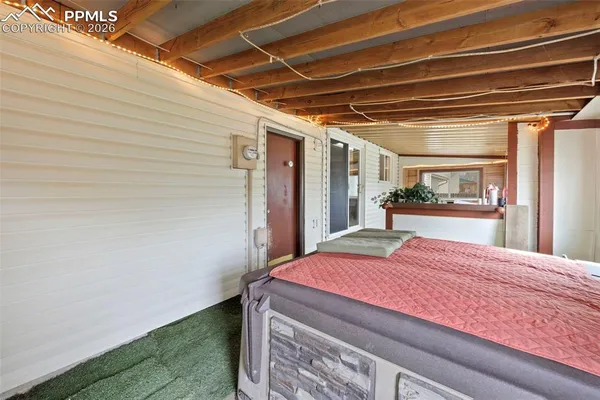 a view of a house with backyard porch and sitting area