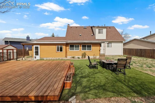 a view of a house with a wooden deck