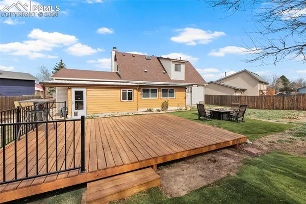 a view of backyard with wooden fence